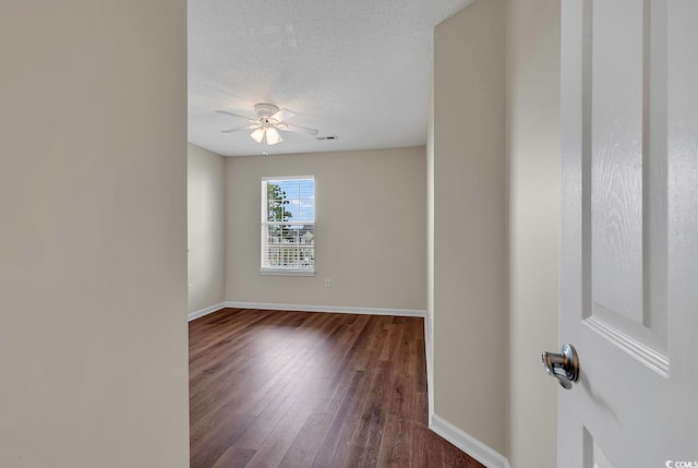 spare room with hardwood / wood-style flooring, a textured ceiling, and ceiling fan