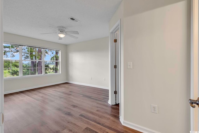 unfurnished room with wood-type flooring, a textured ceiling, and ceiling fan