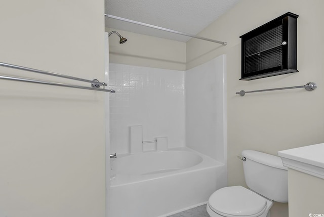 bathroom with bathtub / shower combination, toilet, and a textured ceiling