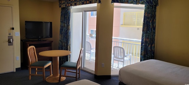 carpeted bedroom featuring multiple windows