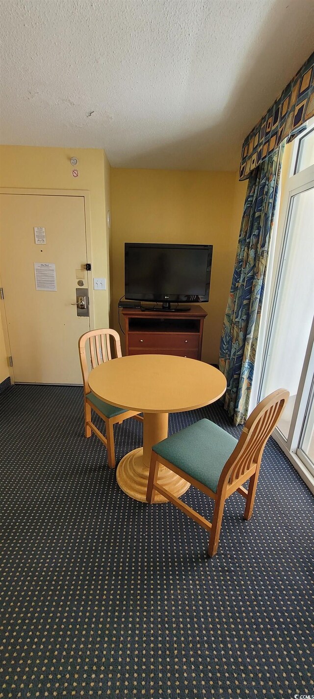 2701 S Ocean Blvd Unit 1410, North Myrtle Beach, SC 29582 - dining area with carpet and a textured ceiling