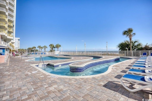 view of pool with a patio and a jacuzzi