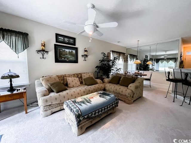 living room featuring light carpet and ceiling fan