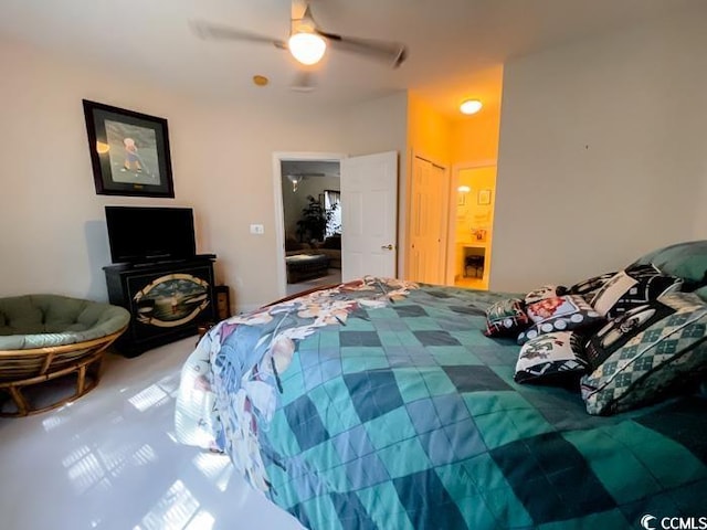 bedroom featuring ensuite bath and ceiling fan