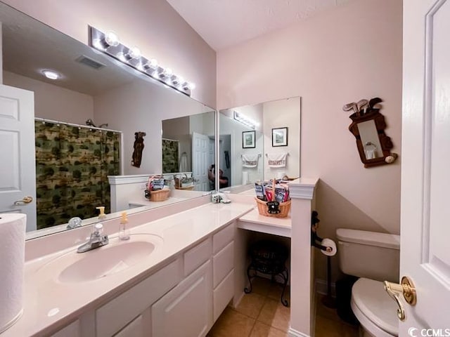 bathroom with vanity, tile patterned flooring, and toilet