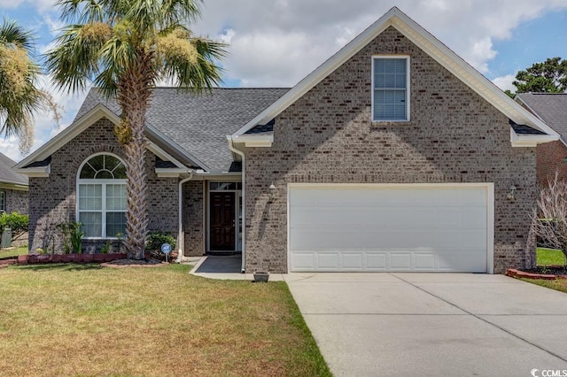 view of front of house featuring a garage and a front lawn