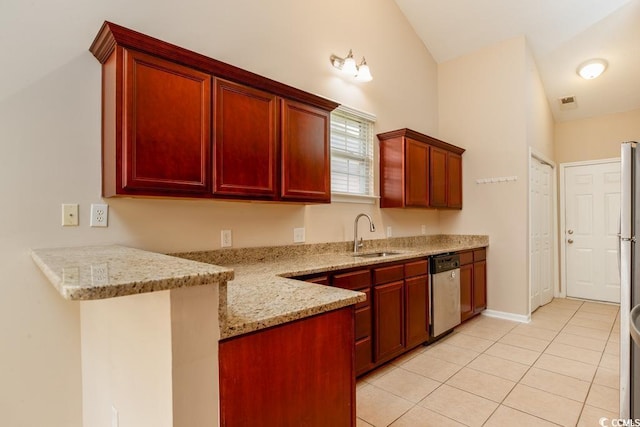 kitchen with lofted ceiling, sink, stainless steel dishwasher, light tile patterned flooring, and light stone counters