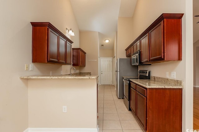 kitchen featuring light stone countertops, appliances with stainless steel finishes, sink, and light tile patterned flooring