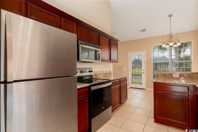 kitchen with light stone countertops, stainless steel appliances, light tile patterned floors, pendant lighting, and a notable chandelier