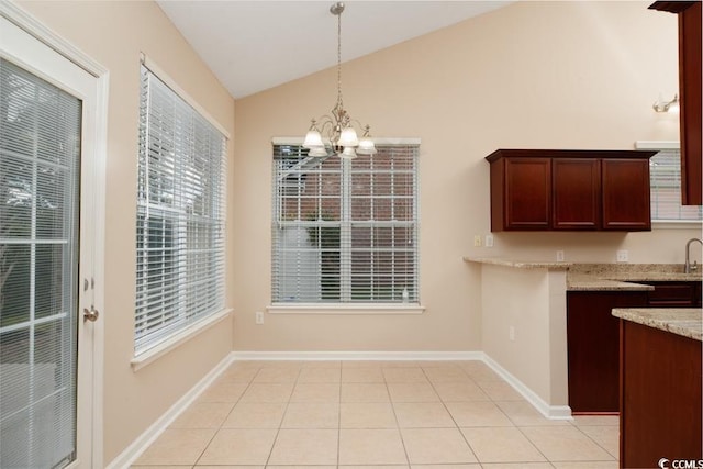 unfurnished dining area featuring an inviting chandelier, vaulted ceiling, and light tile patterned flooring