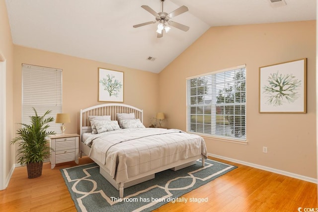 bedroom featuring hardwood / wood-style floors, ceiling fan, and lofted ceiling