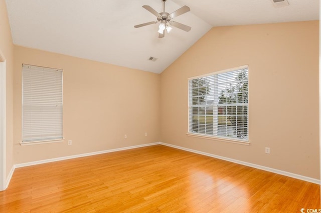 empty room featuring hardwood / wood-style floors, ceiling fan, and vaulted ceiling