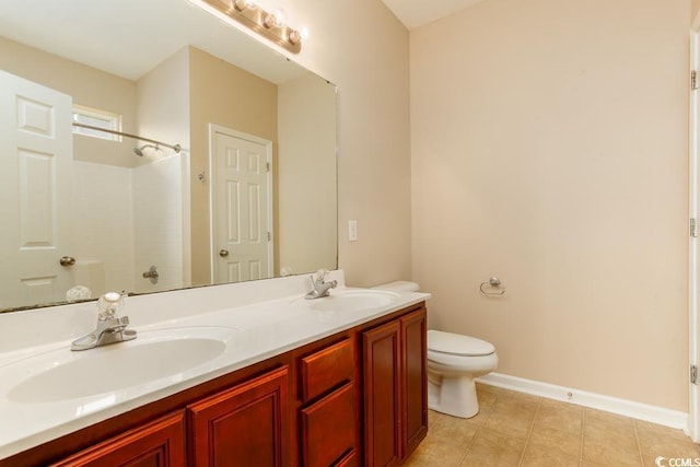 bathroom featuring toilet, a shower, and vanity