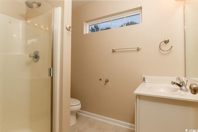 bathroom featuring toilet, vanity, and walk in shower