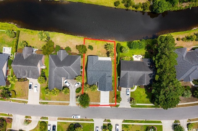 birds eye view of property featuring a water view