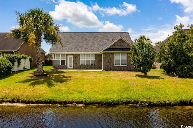 view of front of house featuring a water view and a front lawn