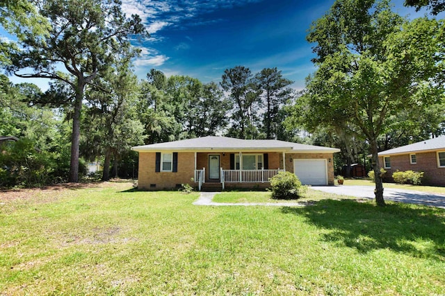 ranch-style house with covered porch, a garage, and a front lawn