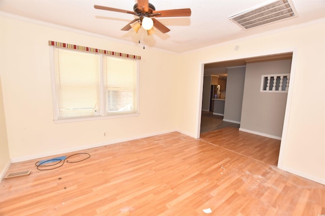 empty room featuring hardwood / wood-style flooring, ceiling fan, and crown molding