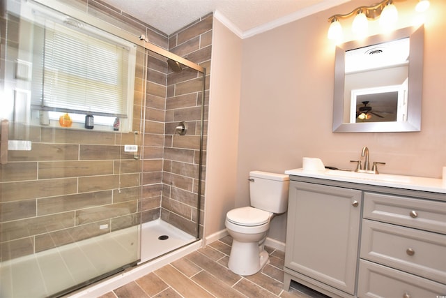 bathroom featuring vanity, toilet, walk in shower, and ornamental molding