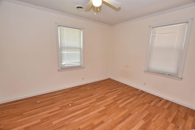 spare room featuring ceiling fan, light wood-type flooring, and crown molding