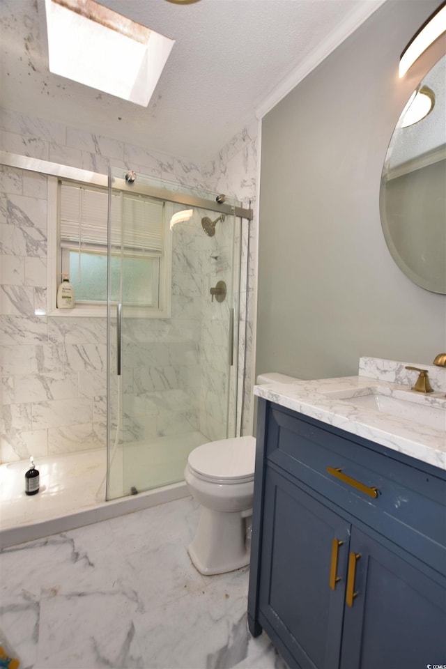 bathroom with a skylight, an enclosed shower, vanity, crown molding, and toilet