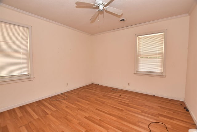 spare room featuring crown molding, ceiling fan, and light hardwood / wood-style floors