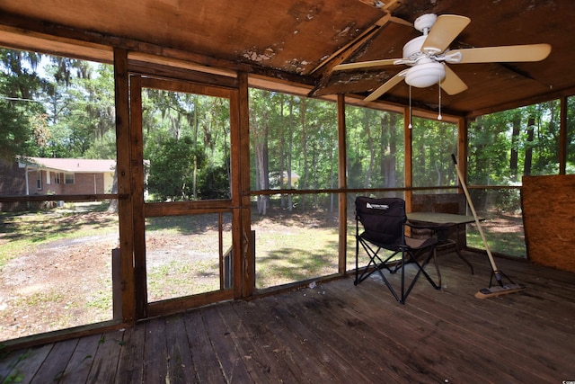 unfurnished sunroom featuring a wealth of natural light and ceiling fan