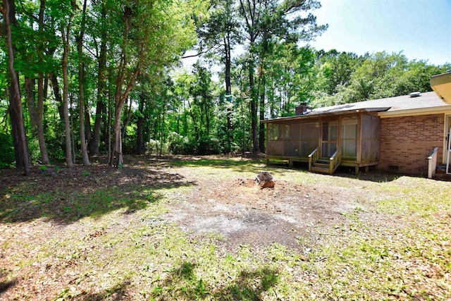 view of yard featuring a sunroom