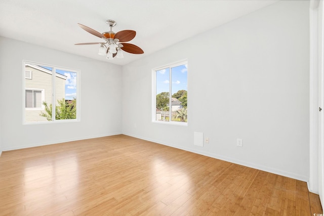 unfurnished room featuring a healthy amount of sunlight, light wood-style flooring, and baseboards