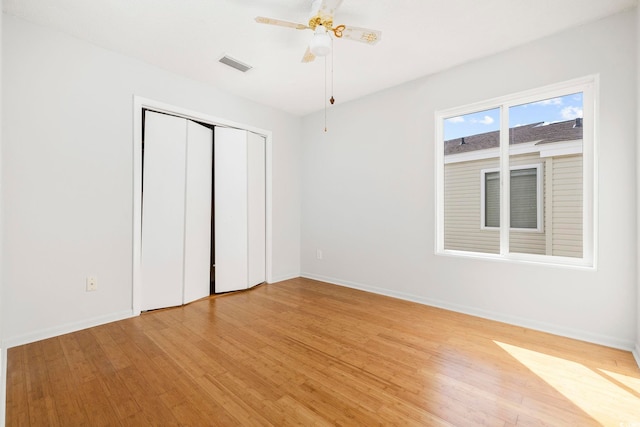 unfurnished bedroom with light wood-style floors, visible vents, and baseboards