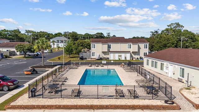 pool featuring fence and a patio