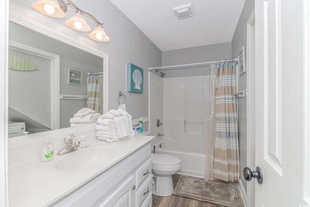 full bathroom featuring toilet, a textured ceiling, vanity, shower / bath combo, and hardwood / wood-style floors