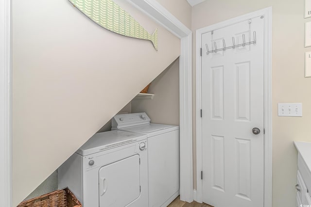 clothes washing area with washing machine and dryer