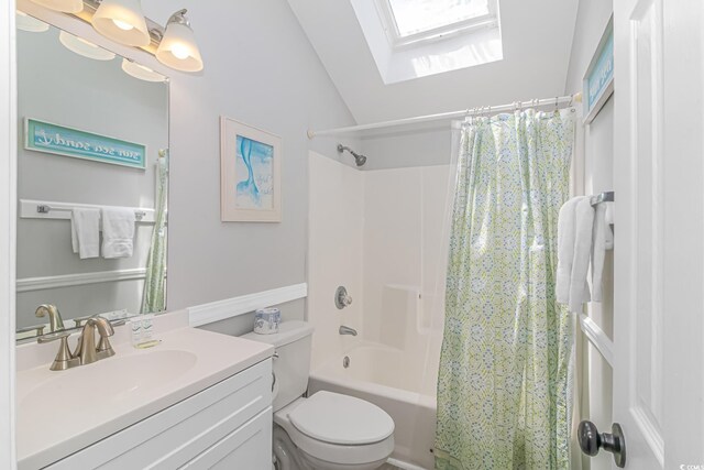 full bathroom with shower / tub combo, vanity, lofted ceiling with skylight, and toilet