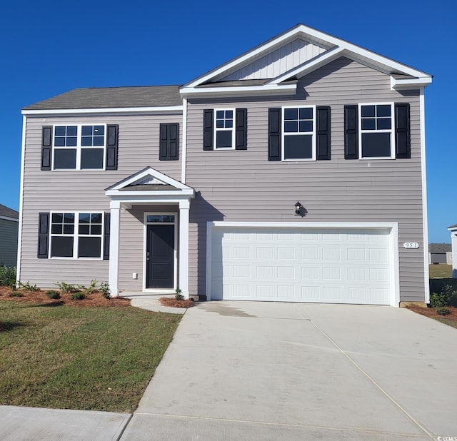 view of front of house with a front yard and a garage