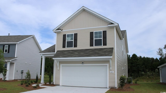 view of side of property with a garage and a lawn