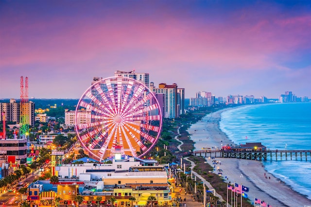 property's view of city featuring a water view and a beach view