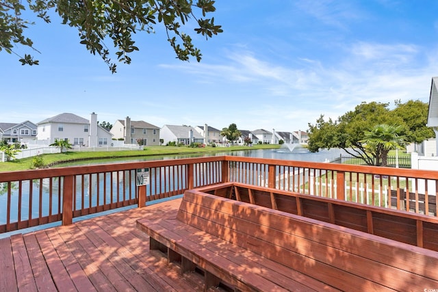 deck featuring a lawn and a water view