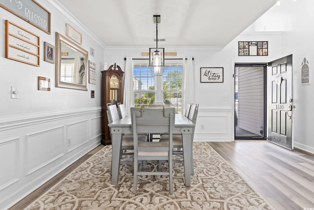 dining room with wood-type flooring and ornamental molding