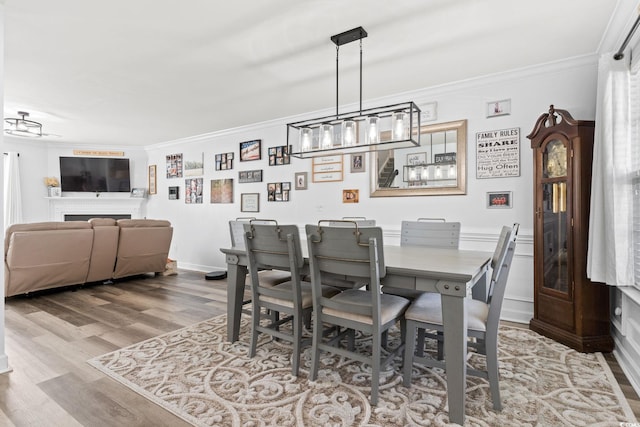 dining room featuring hardwood / wood-style flooring and crown molding