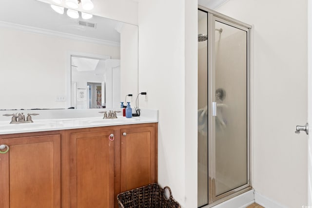 bathroom with vanity, crown molding, and a shower with shower door