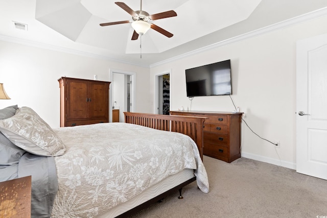 bedroom with light carpet, a raised ceiling, ceiling fan, and ornamental molding