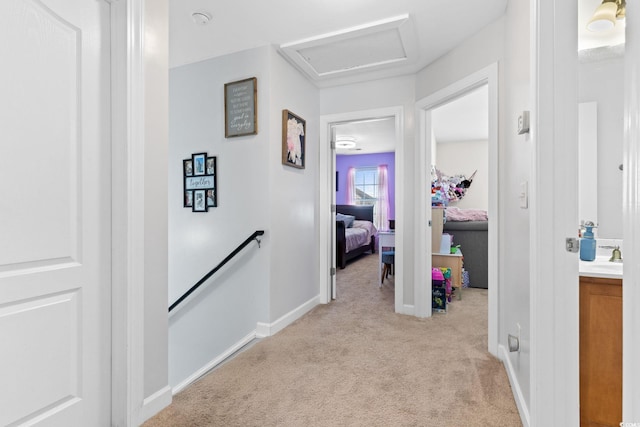 hallway featuring light carpet