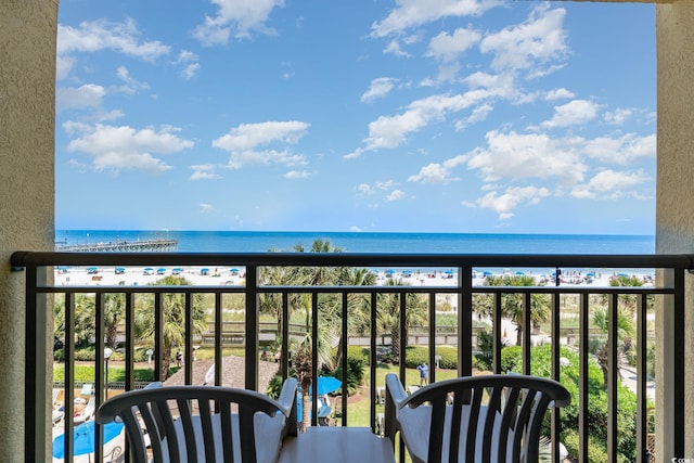 balcony with a water view and a beach view