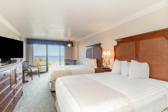 bedroom with carpet floors, a textured ceiling, a water view, and ornamental molding