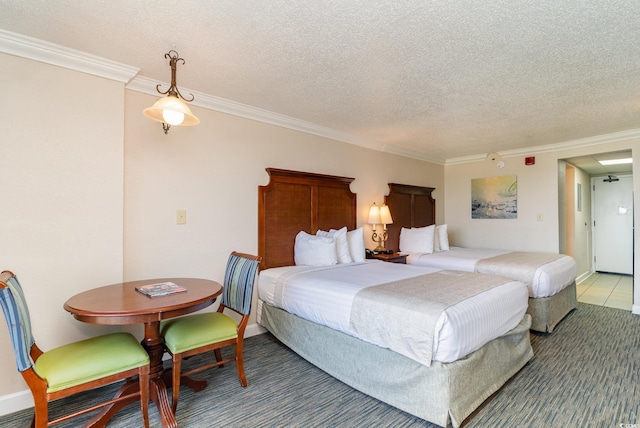 bedroom featuring a textured ceiling and crown molding