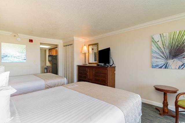 bedroom with a textured ceiling, black fridge, and crown molding