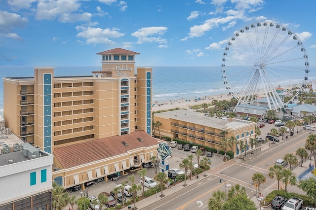 view of building exterior featuring a view of the beach and a water view