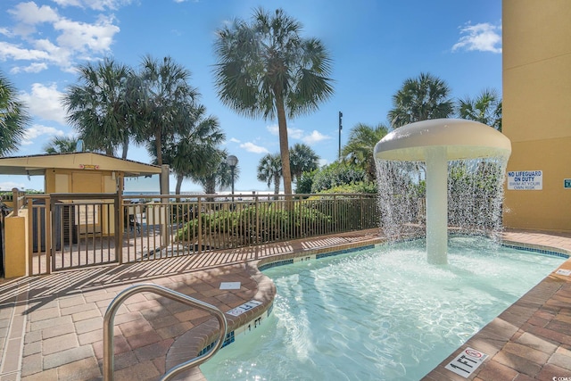 view of swimming pool with pool water feature