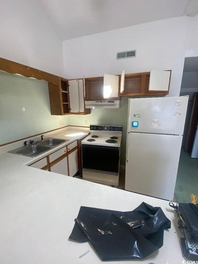 1880 Colony Dr Unit 10-H, Surfside Beach, SC 29575 - kitchen featuring a sink, visible vents, white appliances, under cabinet range hood, and light countertops